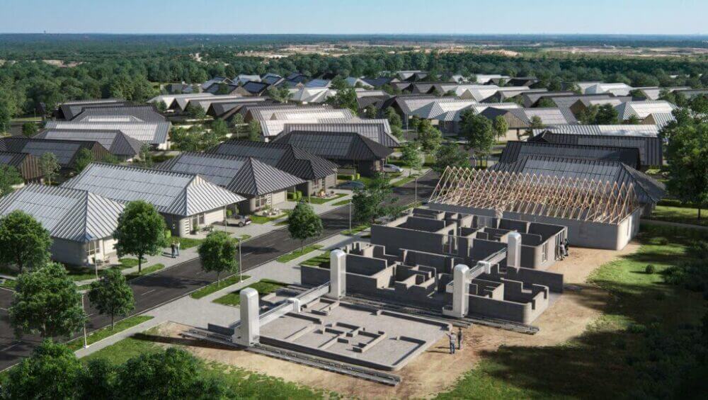 Vista aérea de Wolf Ranch con viviendas impresas en 3D y robots de construcción trabajando sobre estructuras residenciales.